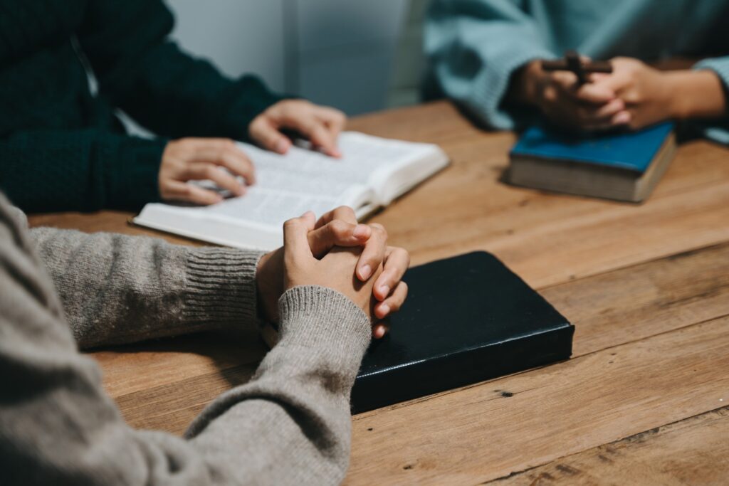 3 people gathered around a table studying